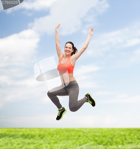 Image of sporty teenage girl jumping in sportswear