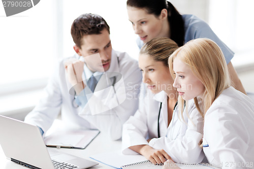 Image of group of doctors looking at tablet pc