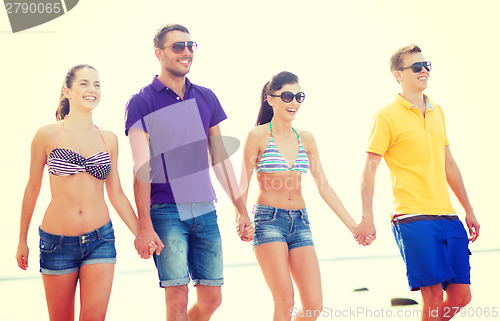 Image of group of friends having fun on the beach