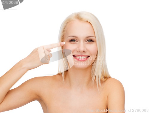 Image of beautiful woman touching her eye area