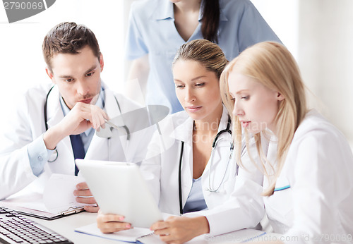 Image of group of doctors looking at tablet pc