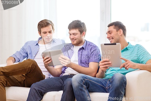 Image of smiling friends with tablet pc computers at home