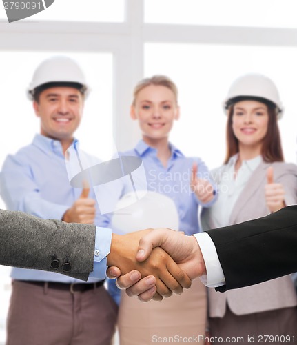 Image of businessman and businesswoman shaking hands