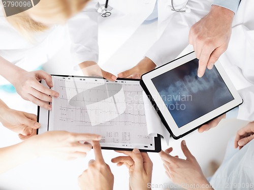 Image of group of doctors looking at x-ray on tablet pc