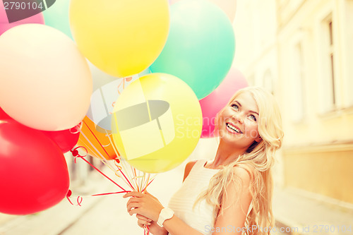 Image of smiling woman with colorful balloons