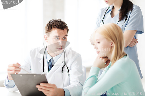 Image of doctor and nurse with patient in hospital