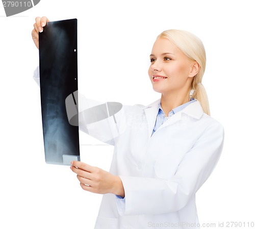 Image of smiling female doctor looking at x-ray