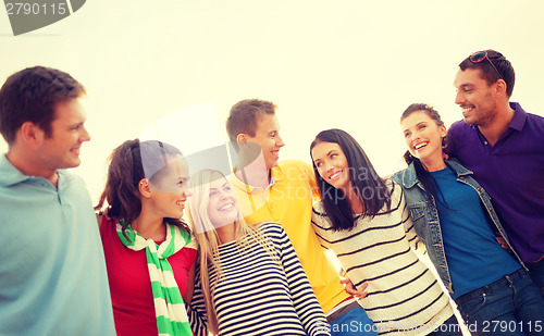 Image of group of friends having fun on the beach