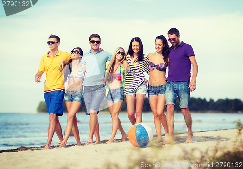 Image of group of friends having fun on the beach