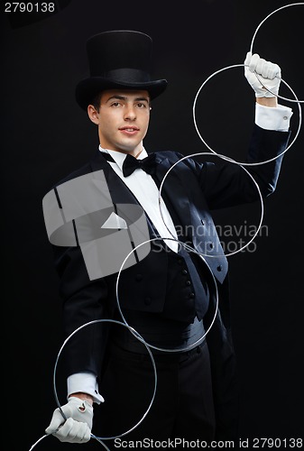 Image of magician showing trick with linking rings