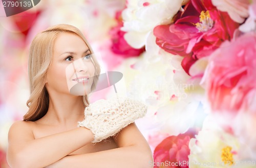 Image of smiling woman with exfoliation glove