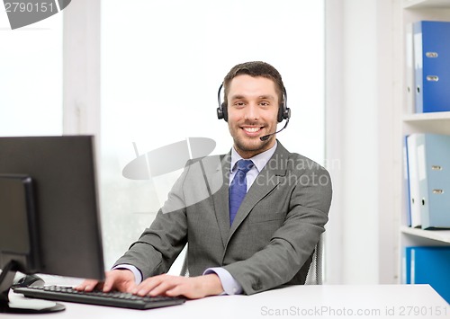 Image of helpline operator with headphones and computer