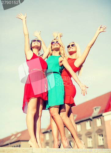 Image of three beautiful women in the city