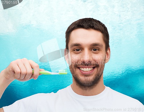 Image of smiling young man with toothbrush