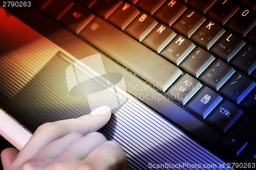 Image of Working at laptop .