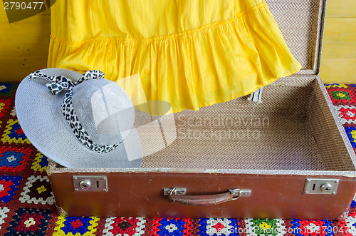 Image of gray femalee hat suitcase yellow dresses fragment