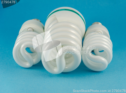 Image of eco economy fluorescent lamp on blue background 