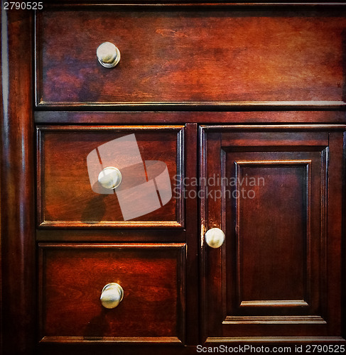 Image of Dark wooden chest of drawers