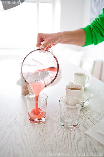 Image of Pouring a delicious strawberry smoothie