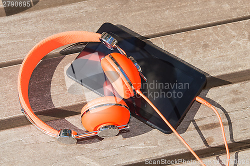 Image of Orange headphones and tablet pc