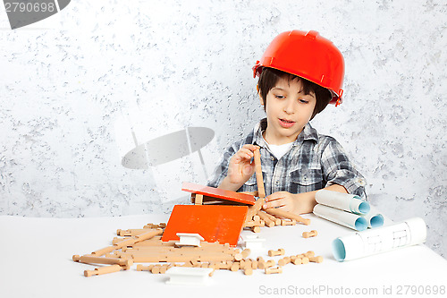 Image of boy plans to build a house