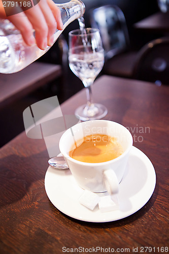 Image of Cup of espresso and pouring water