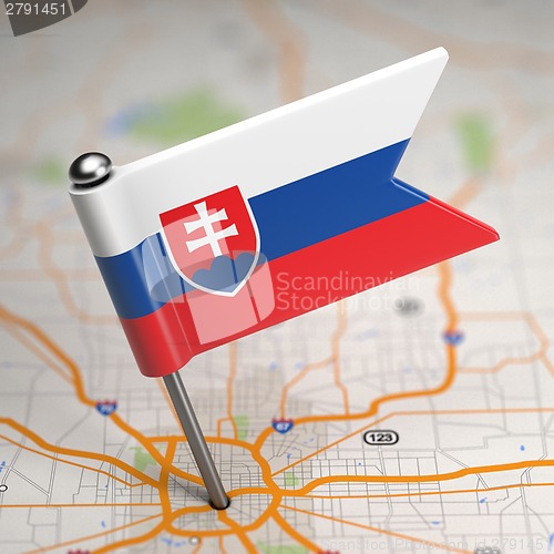 Image of Slovakia Small Flag on a Map Background.