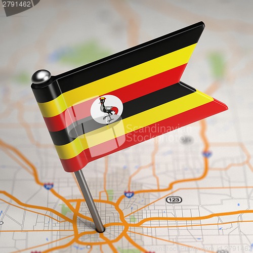 Image of Uganda Small Flag on a Map Background.