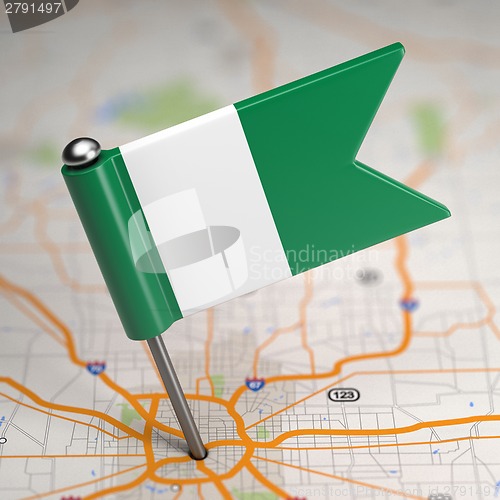 Image of Nigeria Small Flag on a Map Background.