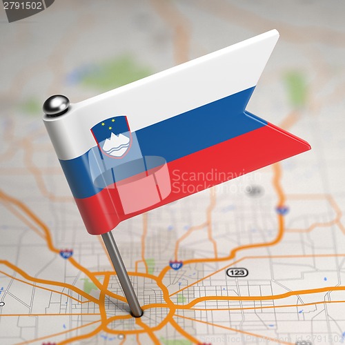 Image of Slovenia Small Flag on a Map Background.