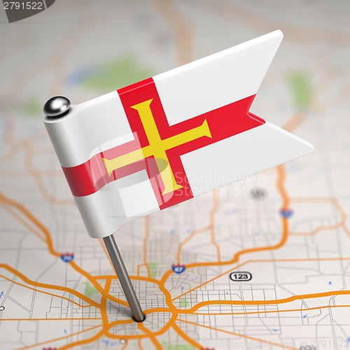 Image of Guernsey Small Flag on a Map Background.