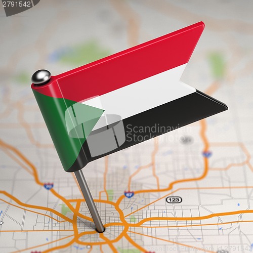 Image of Sudan Small Flag on a Map Background.