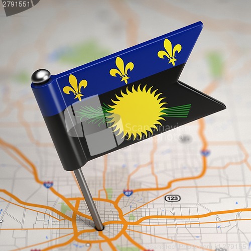 Image of Guadeloupe Small Flag on a Map Background.