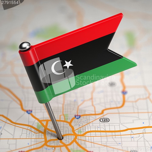 Image of Libya Small Flag on a Map Background.