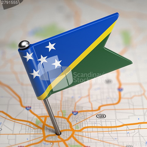 Image of Solomon Islands Small Flag on a Map Background.