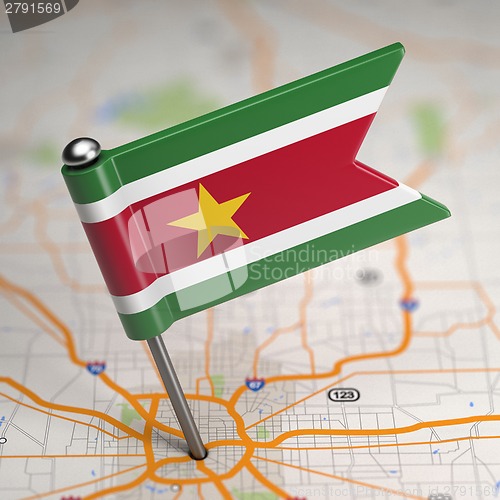 Image of Suriname Small Flag on a Map Background.
