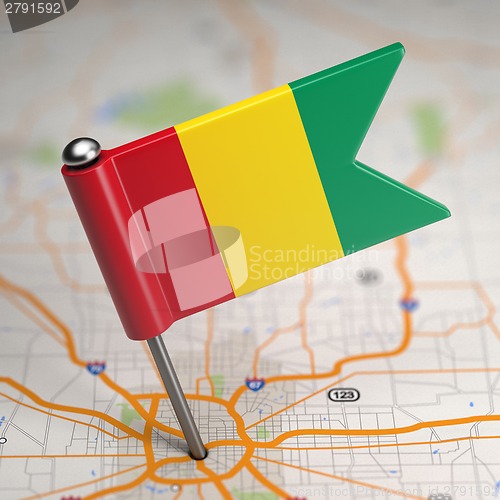 Image of Guinea Small Flag on a Map Background.