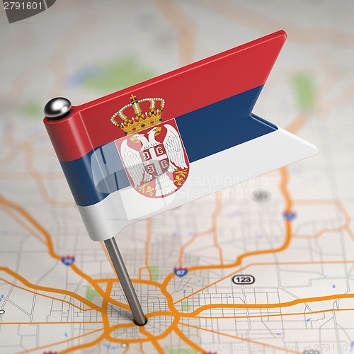 Image of Serbia Small Flag on a Map Background.