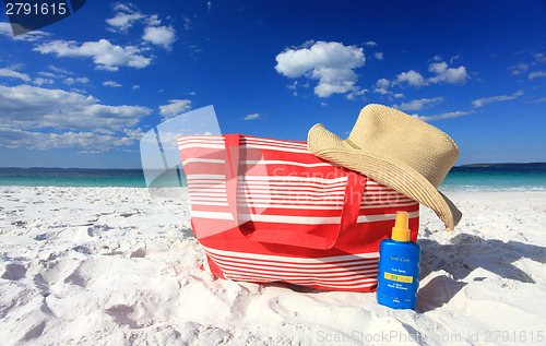 Image of Summertime sun protection sunscreen hat at the beach