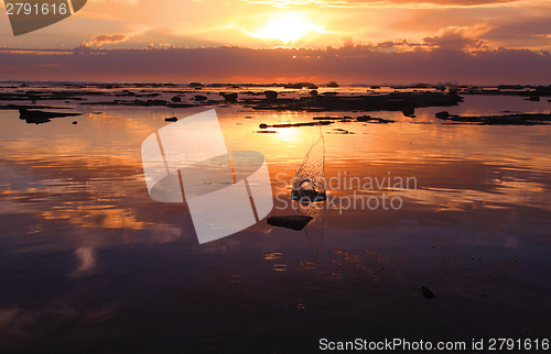 Image of Sunrise pebble slash in ocean rock reef