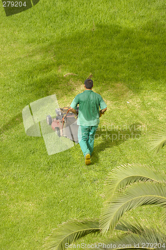 Image of Man mowing grass