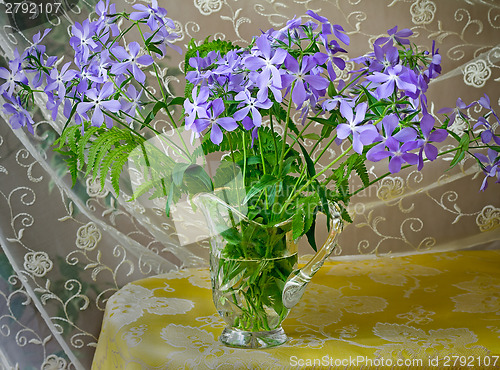 Image of Blossoming violets in a crystal vase.