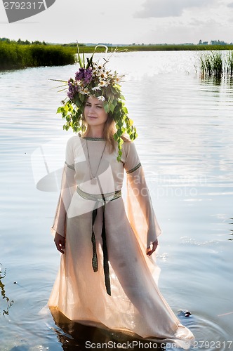 Image of Beautiful sad woman with flower wreath