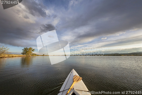 Image of canoe with a paddle on lake