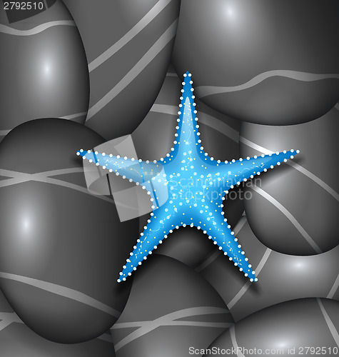 Image of Blue starfish among sea pebble stones