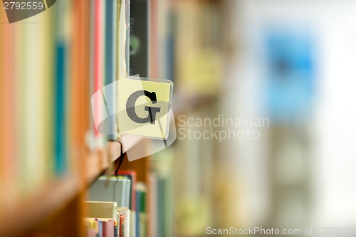 Image of Library bookshelf closeup with letter