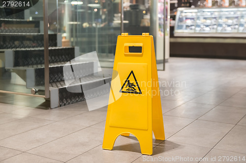 Image of Yellow sign alerts for wet floor