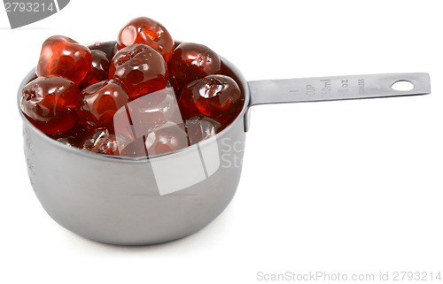 Image of Sticky whole glace cherries in a cup measure