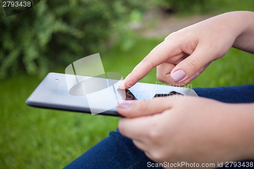 Image of Woman using digital tablet PC