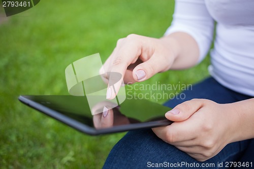 Image of Woman using digital tablet PC